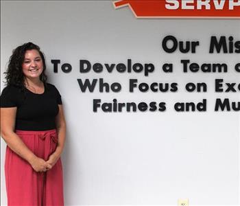 woman in front of mission statement